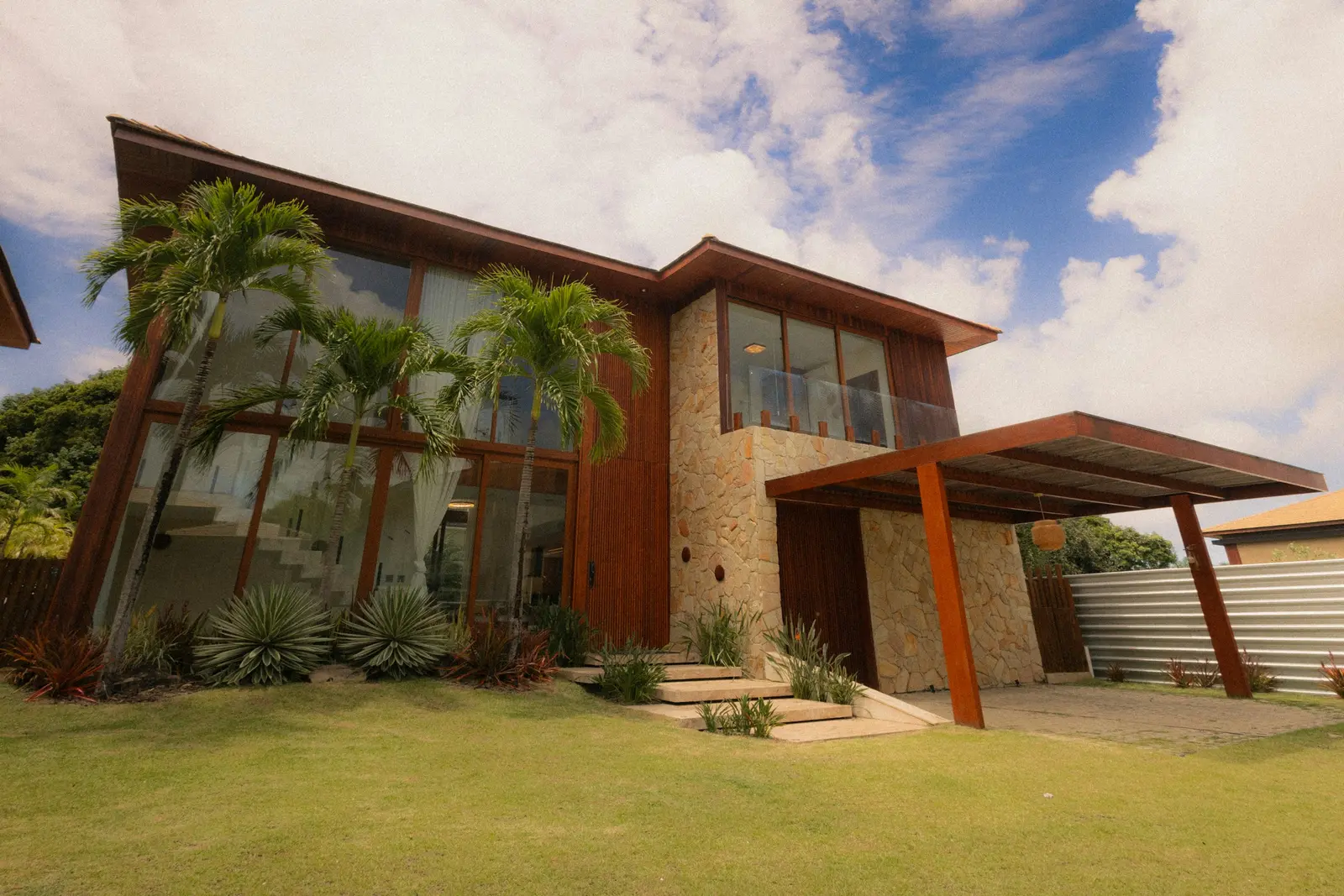 Modern two-storey family home with timber cladding and a landscaped lawn